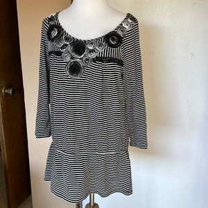 Black and White striped peplum top. Floral appliqué. Size L
